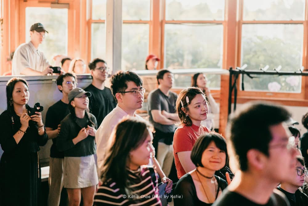 Audience members smiling and reacting during a live show
